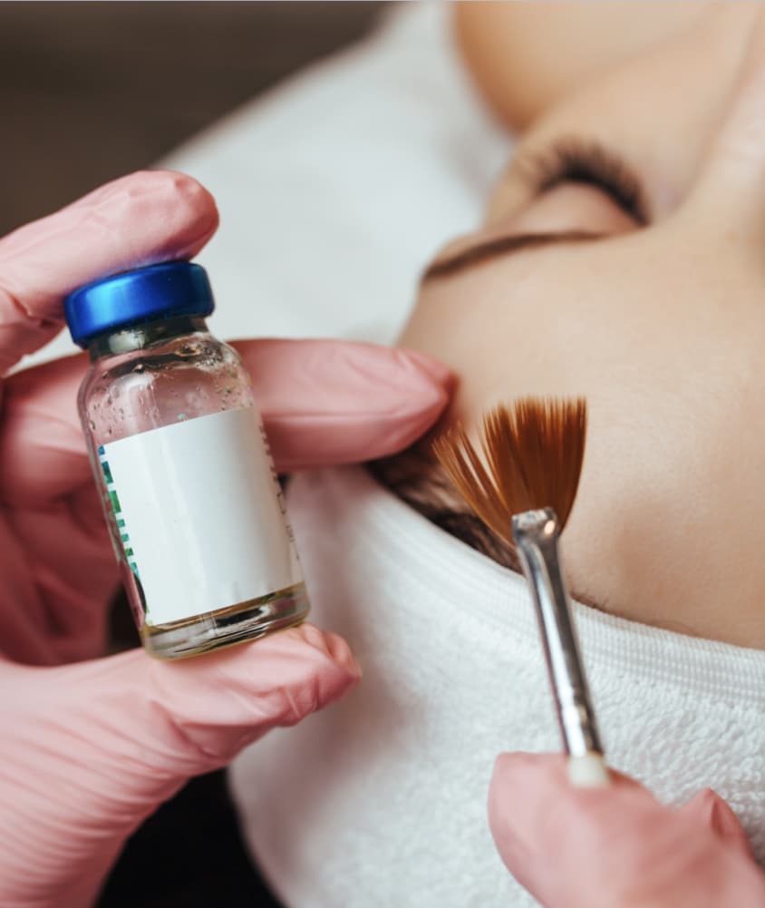 Woman receiving an in-office chemical peel at Allure Aesthetics, serving King of Prussia and greater Philadelphia clients.