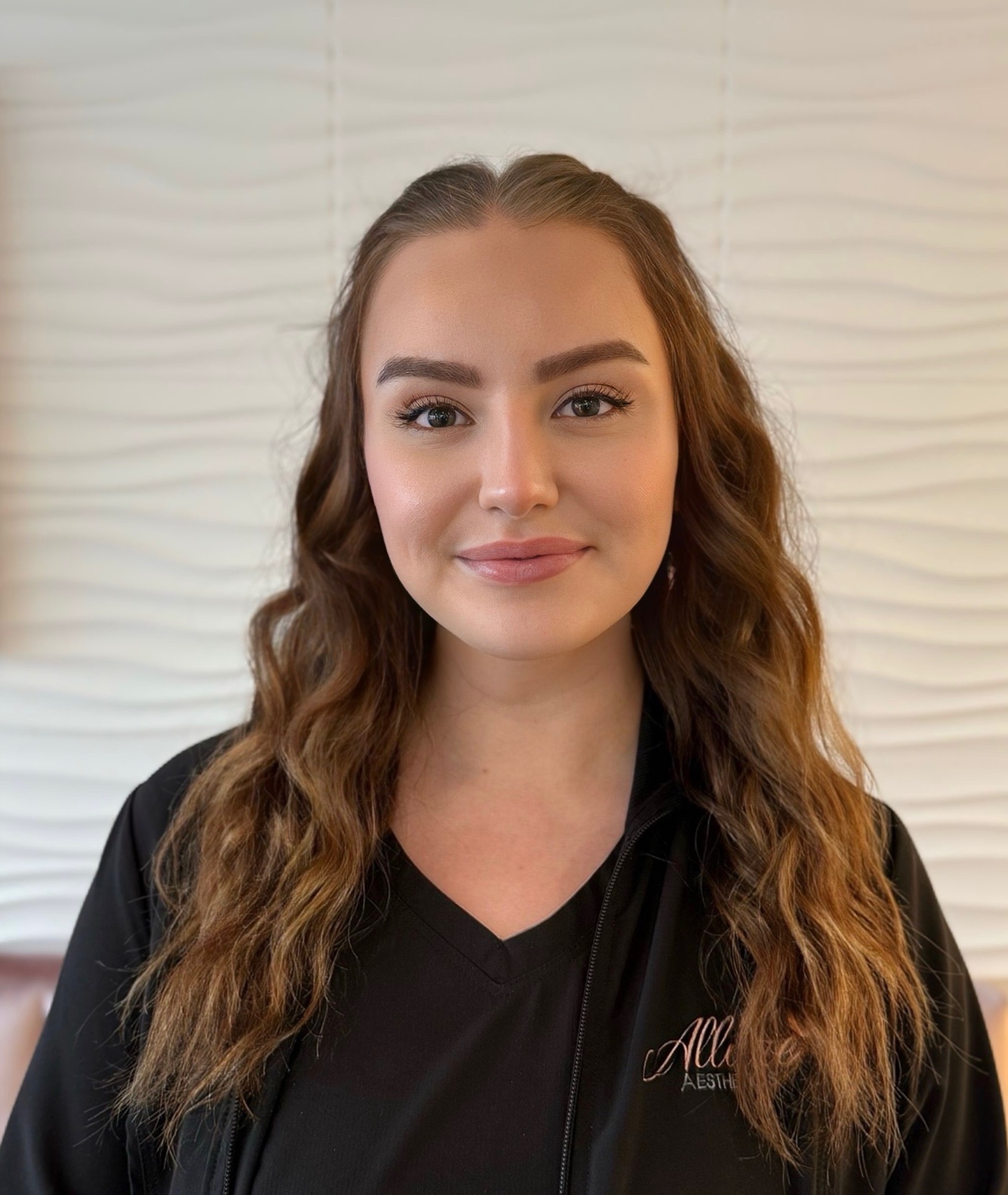 Zoe Sambrick, Medical Assistant at Allure Aesthetics, pictured in a warm, welcoming clinical setting.
