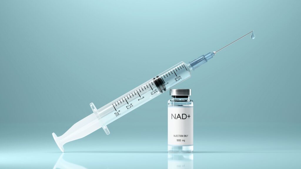 Syringe resting on a medical vial, symbolizing NAD IV therapy